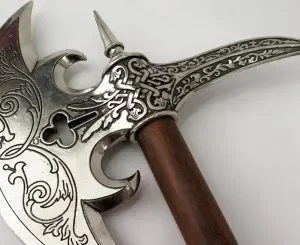 A close up of the handle on an ornate sword.