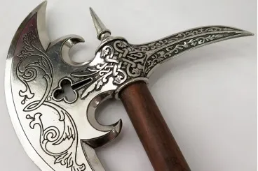 A close up of the handle on an ornate sword.